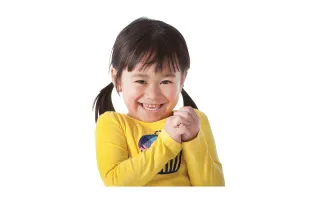 toddler wearing yellow smiling and clapping