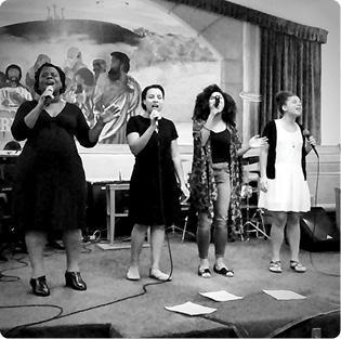 The White Family Singers singing on stage