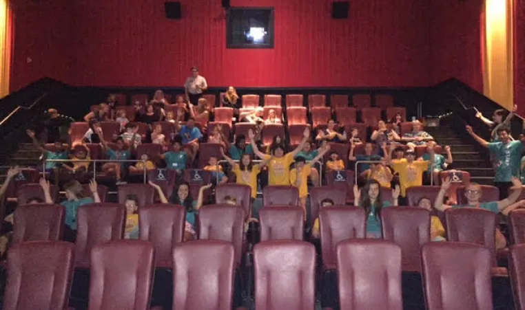 Camp COAST members pose at the movie theatre 
