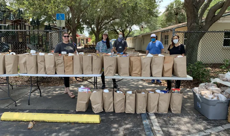 YMCA and local volunteers distribute grocery bags of food