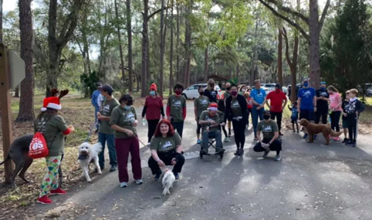 group of people in park for reindeer run 2020 and a few dogs