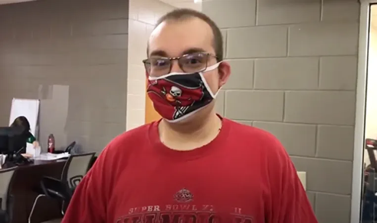 MASH program participant wearing Bucs face covering and red shirt