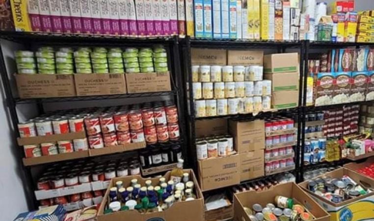 full shelving units with canned goods and nonperishable items