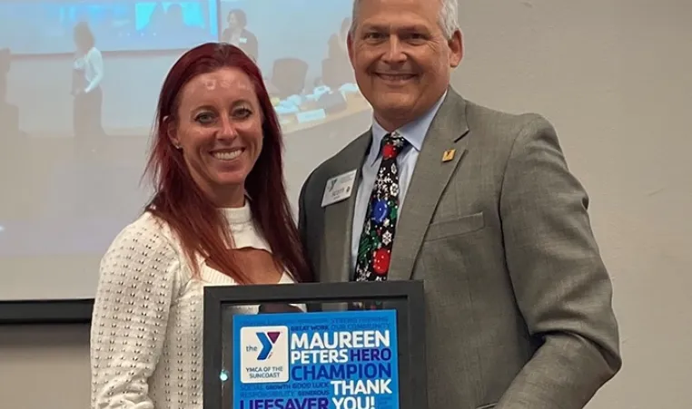 Maureen Peters receiving her congratulary certificate from Scott Goyer