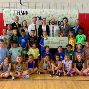 YMCA Campers pose with check donated by Publix Charities
