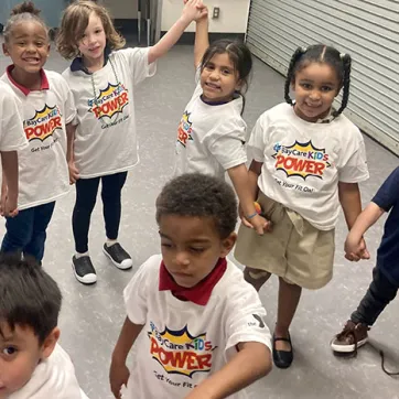 Children wearing 'KIDS POWER' shirts at Skycrest