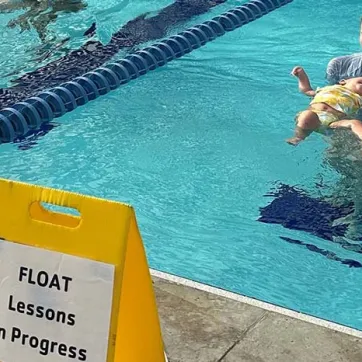 Instructors teaching toddlers to swim in the YMCA of the Suncoast pool.